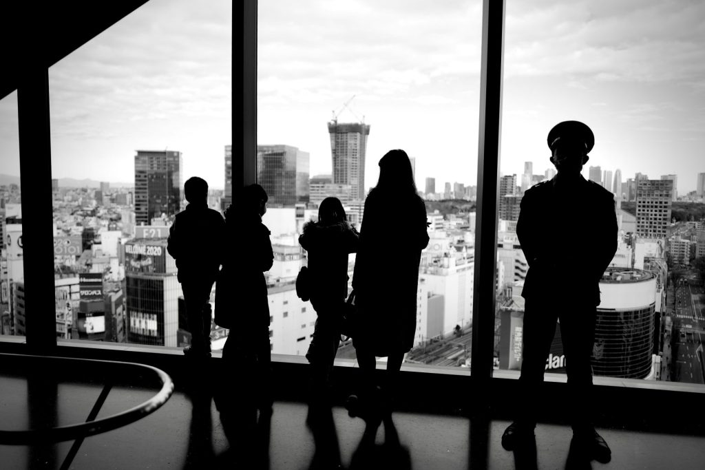 silhouette of people standing near window